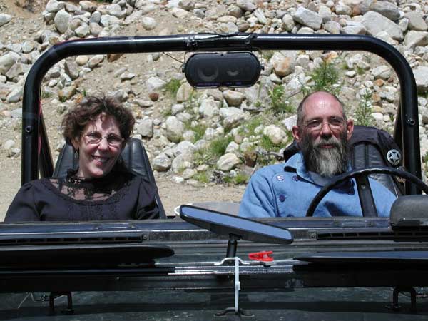 Hermit Joe and Tag-Along-Tess in their classic jeep.