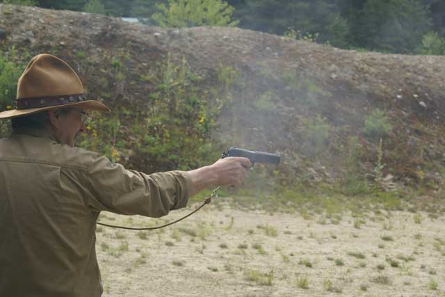 ... and shooting his 1911 pistol.